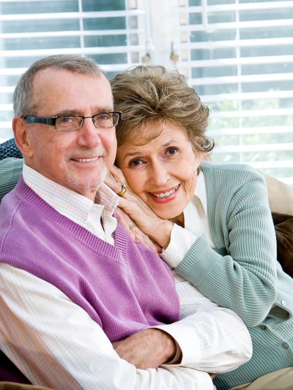 Happy retired couple enjoying their home